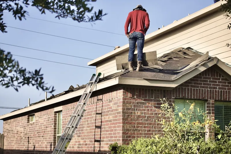 Professional roofer working on a residential roof in Saddle River
